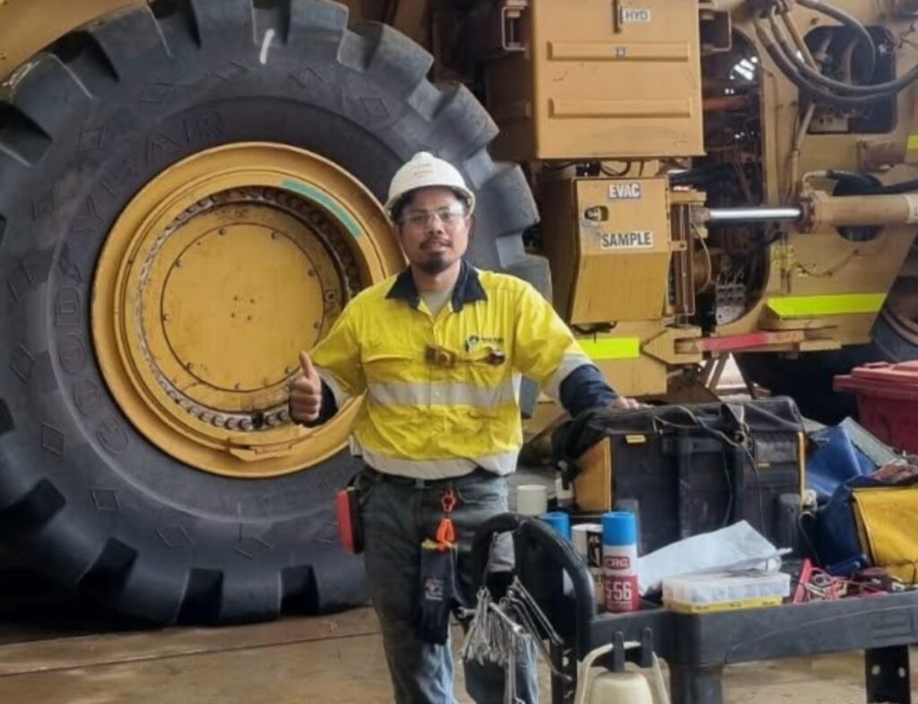 Maintenance mechanic giving a thumbs-up while working on a heavy equipment maintenance project.