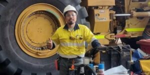 Maintenance mechanic giving a thumbs-up while working on a heavy equipment maintenance project.